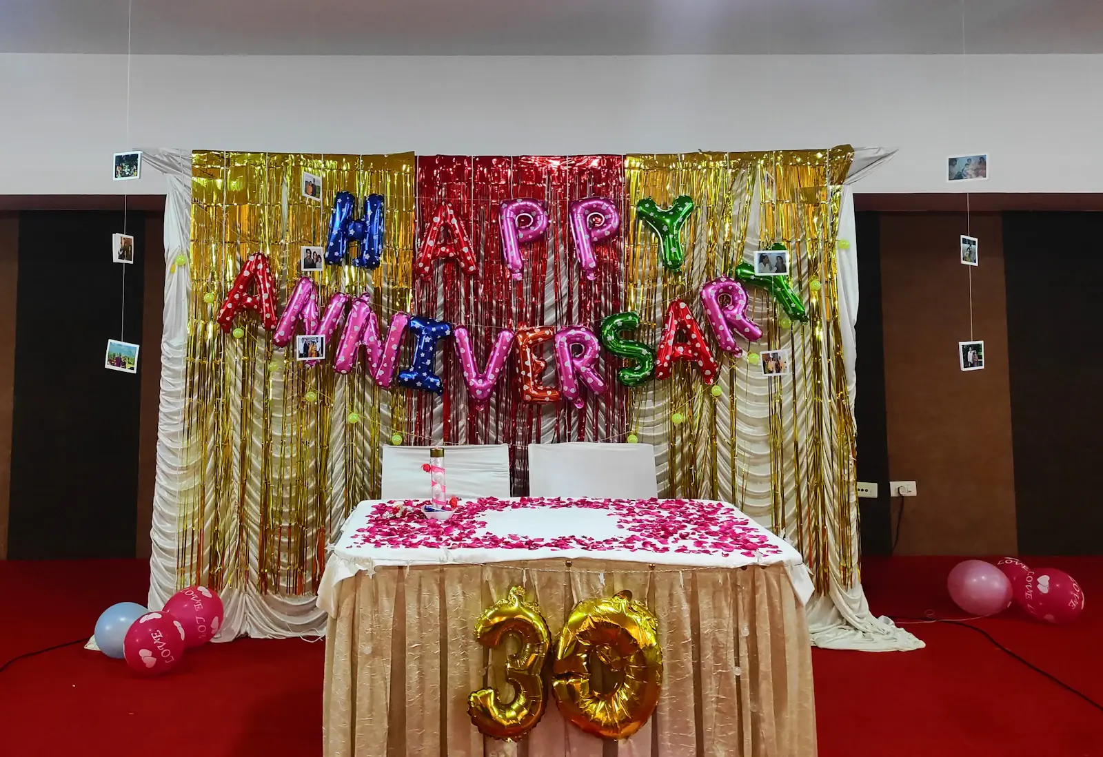 Social Event Planner - Happy Anniversary stage backdrop with a decorated cake table