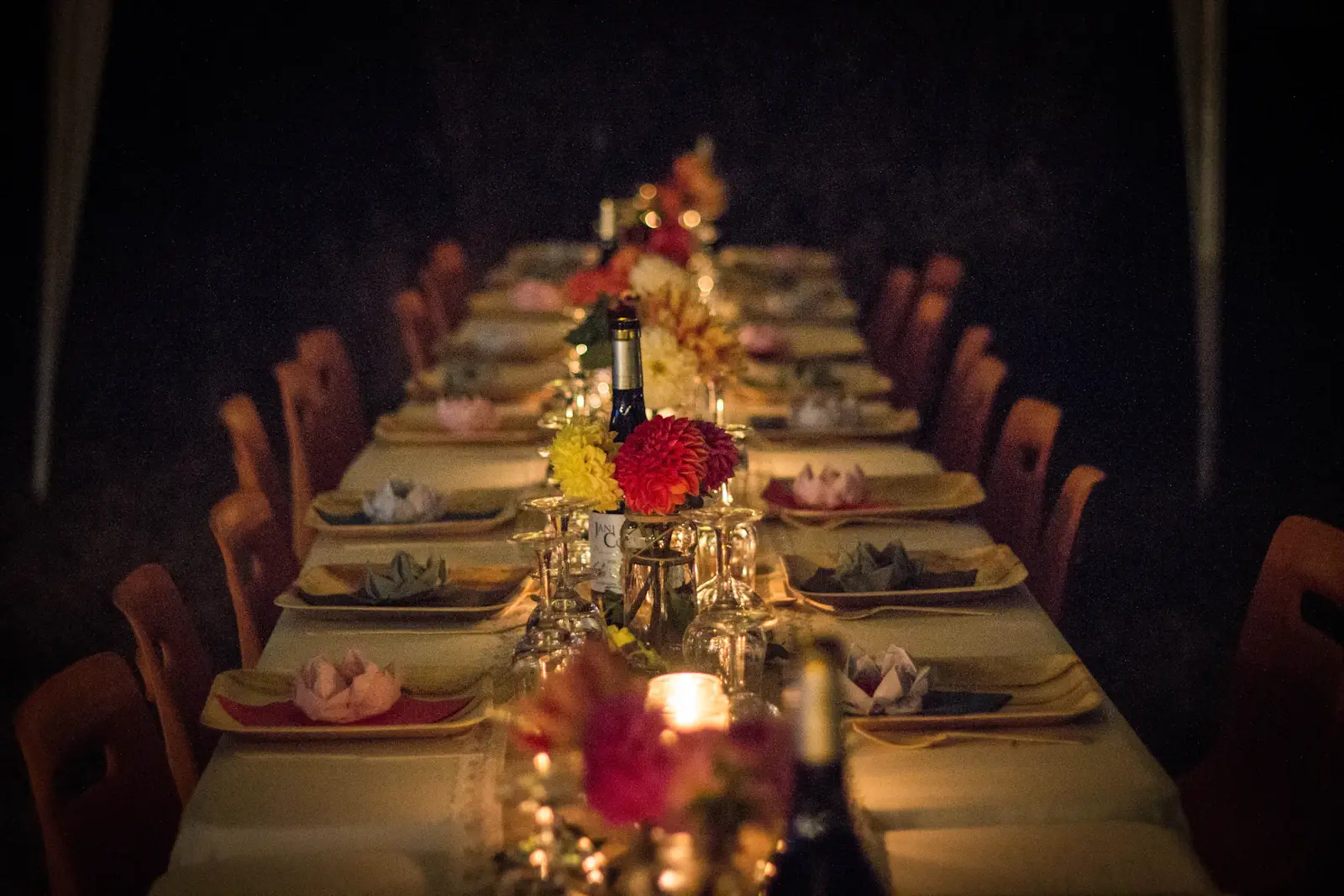 Candlelit long reception table with floral centerpieces