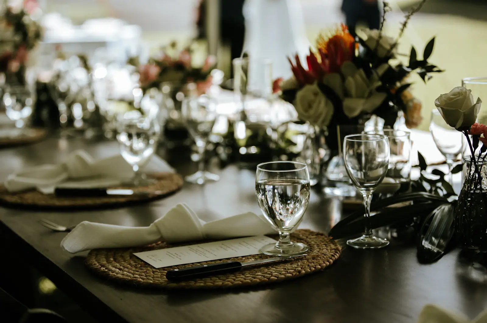 Elegant dining table with floral centerpieces and glassware
