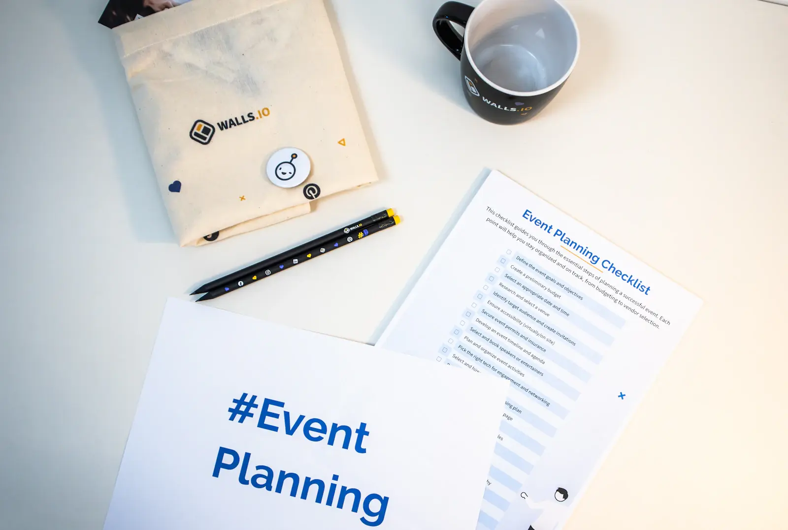 Event planning checklist on a desk with a notebook and coffee mug