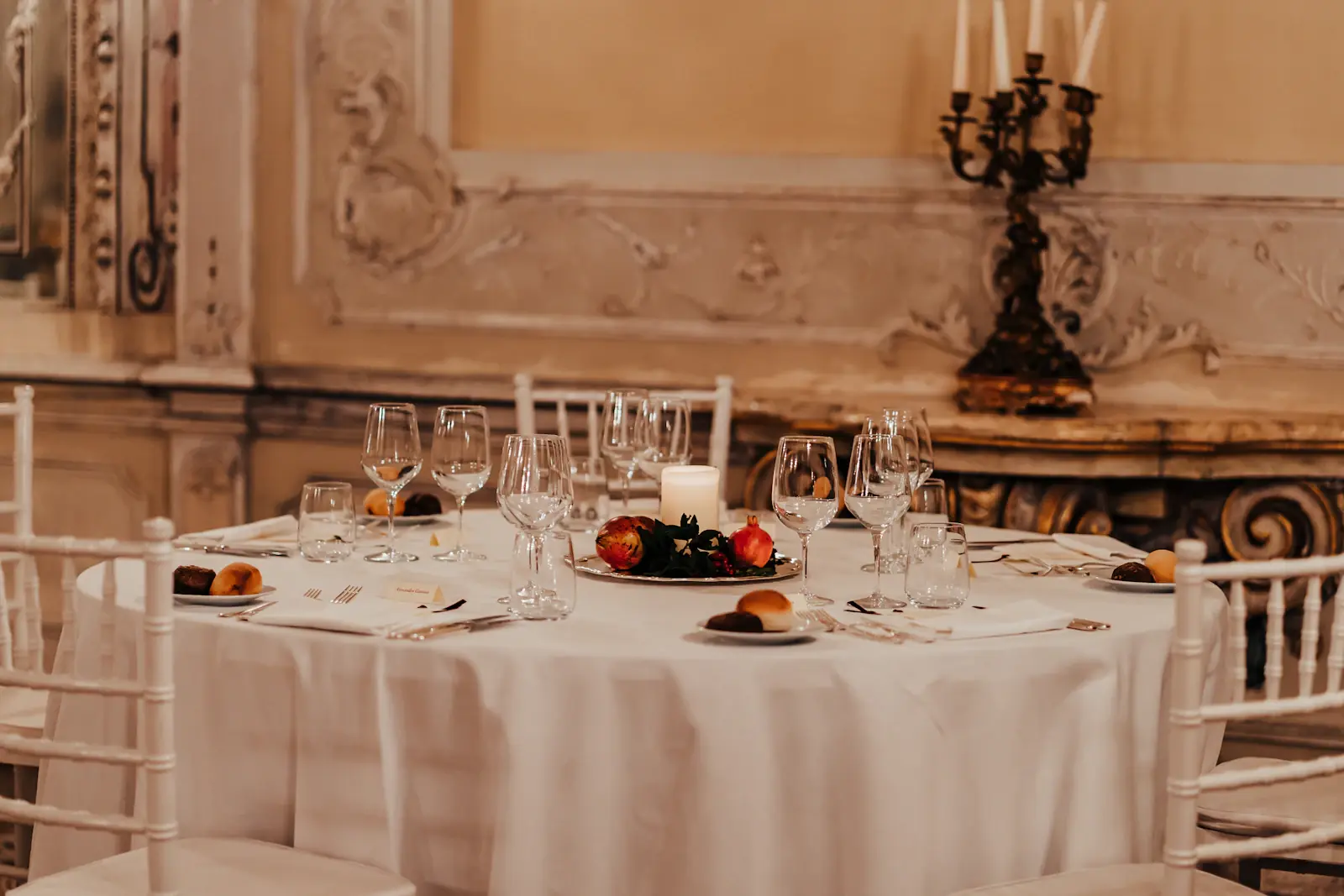 Formal gala dinner table setting with white linen and candelabra