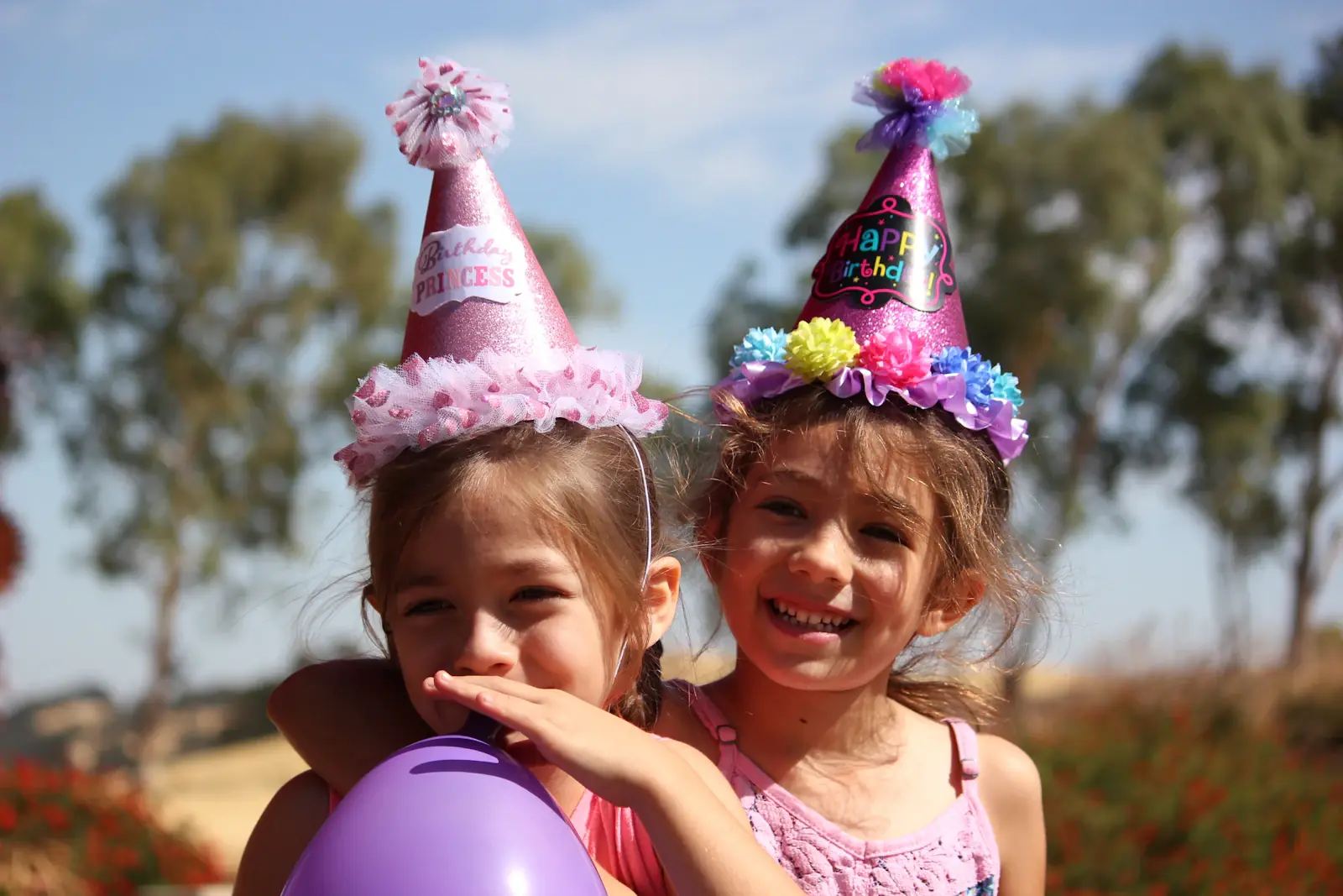 Birthday Party Planner in Lahore - Two girls in party hats at a kids birthday party
