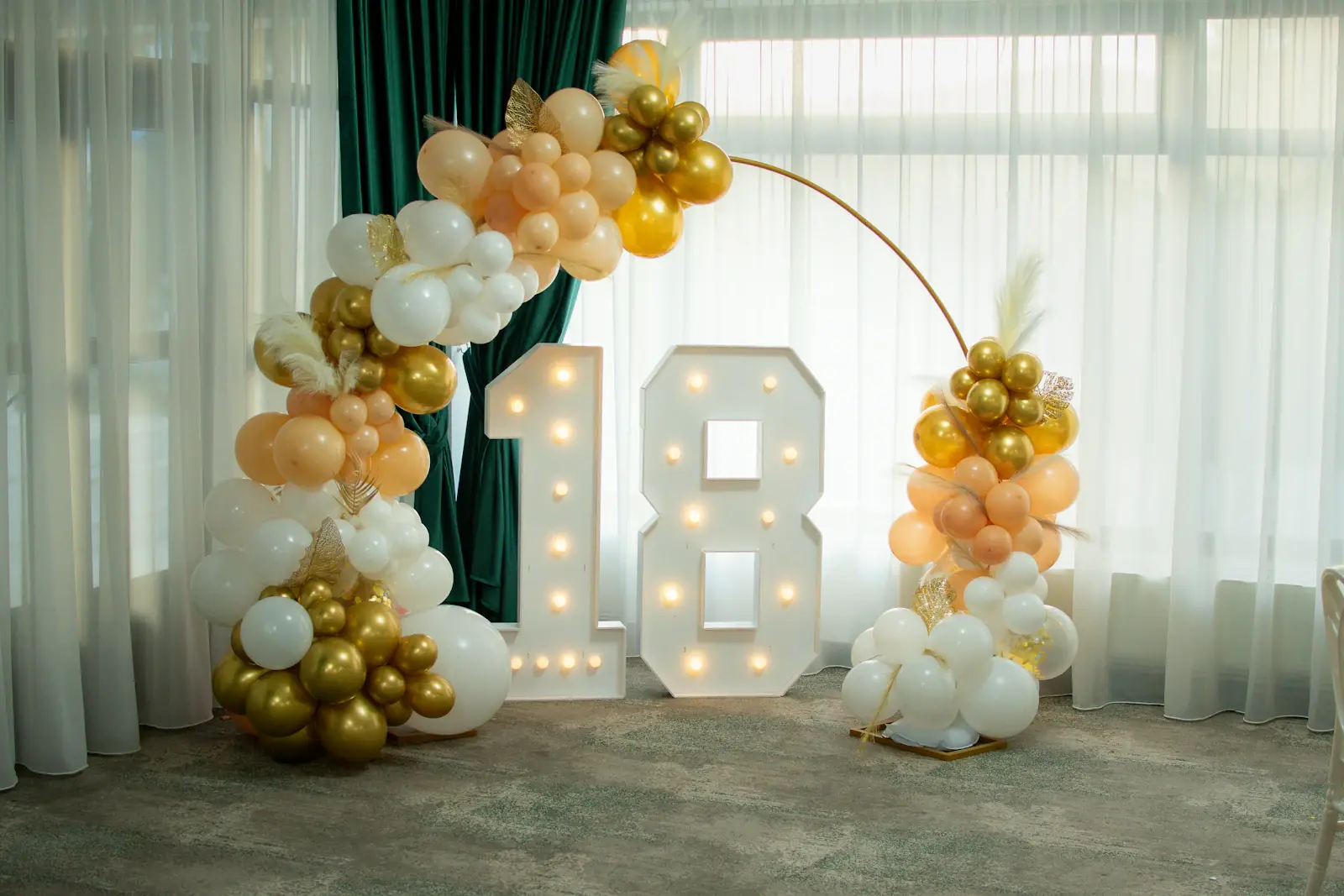 Milestone 18th birthday balloon decoration with lit numbers