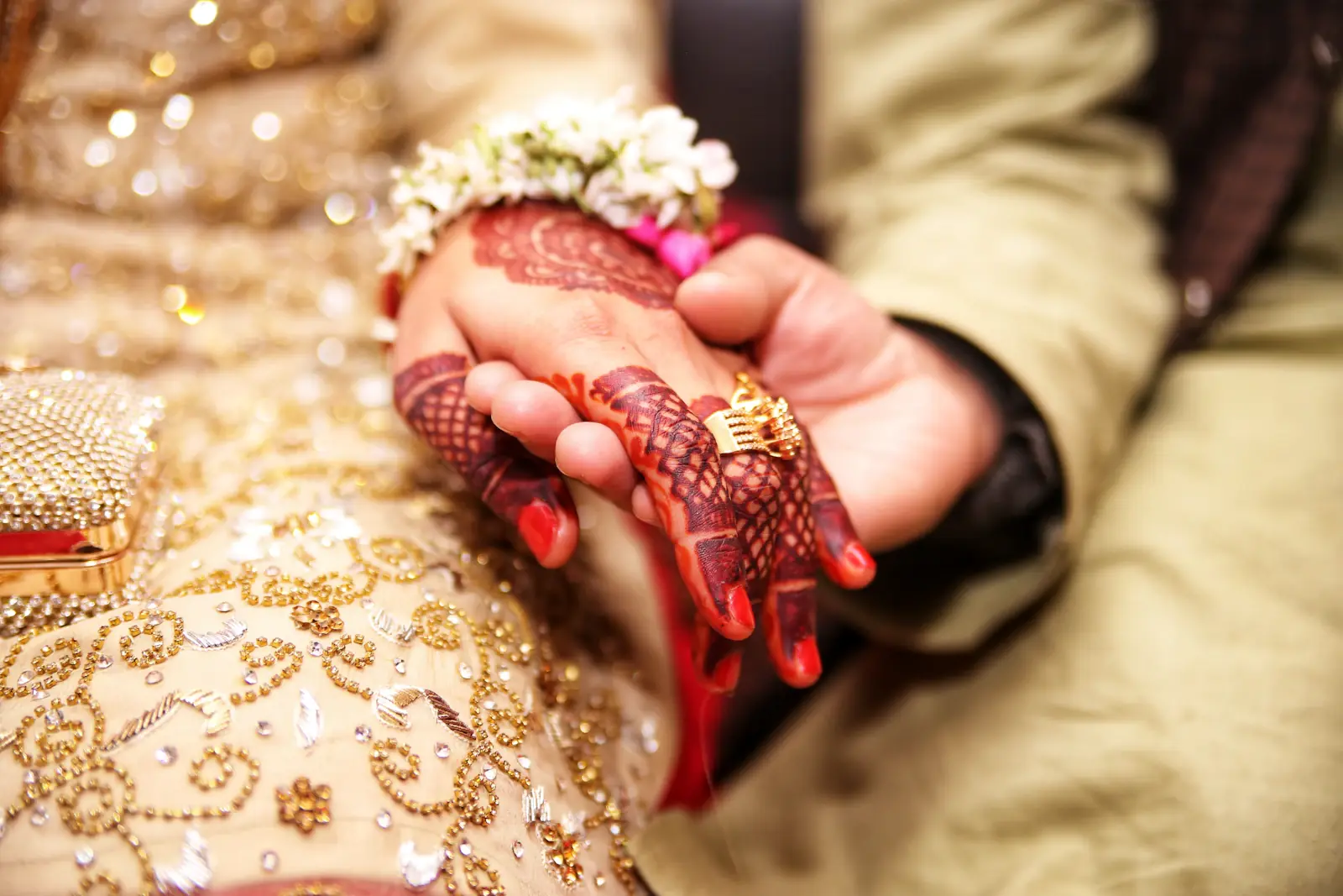 Bridal hands with rings and henna during a nikah ceremony