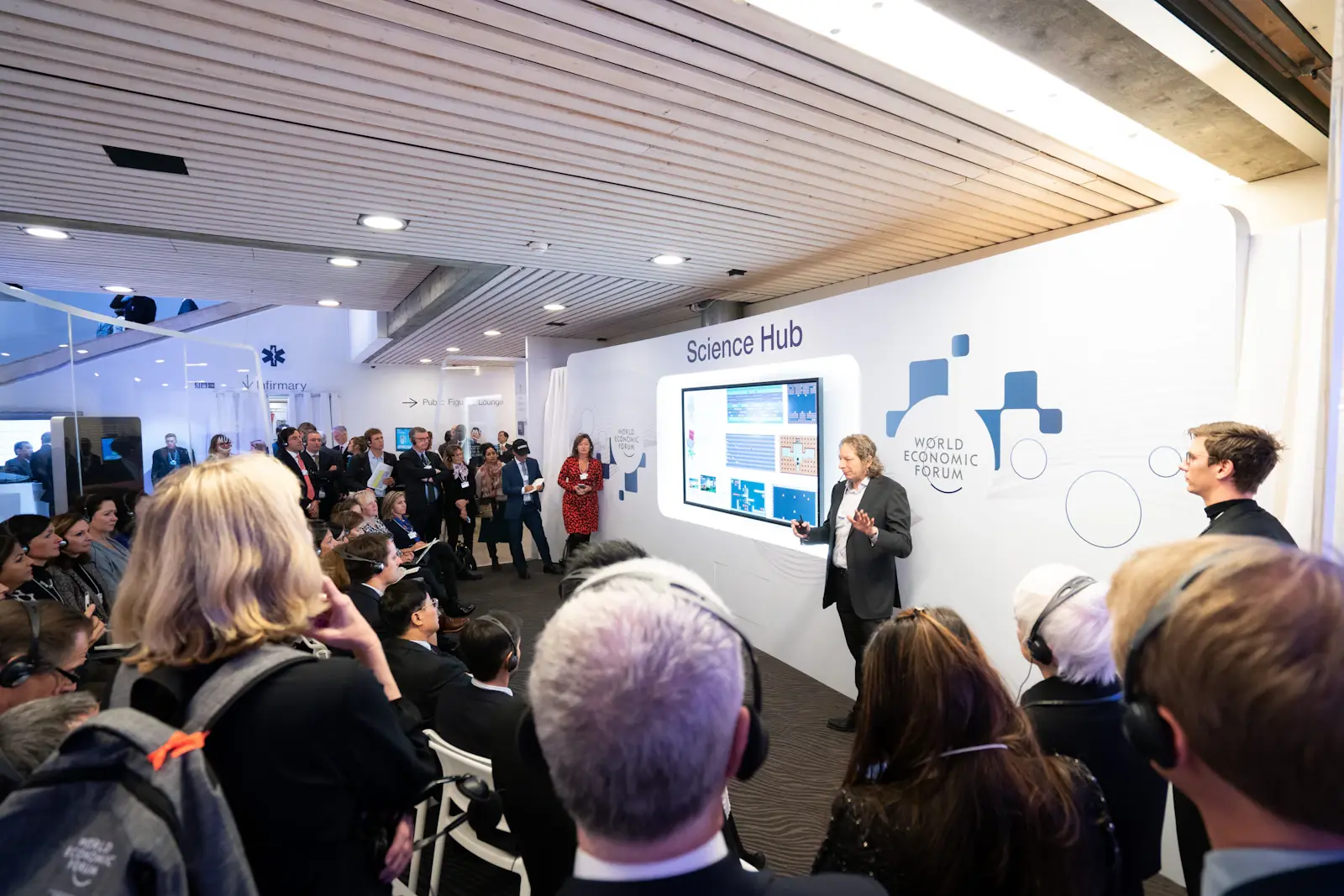 Modern product launch event with guests around a presentation screen